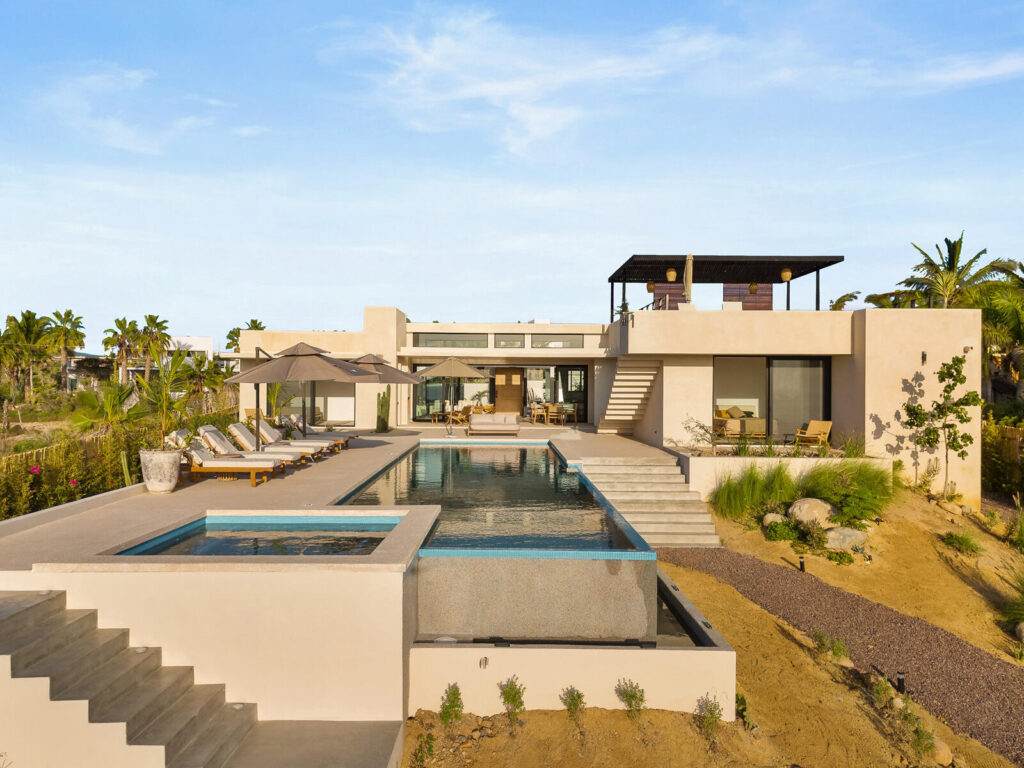 Cabo Luxury Las Tunas The Nacuii Residence is a refined luxury home crafted to exceed the expectations of even the most discerning buyer. Nestled on a generous and private 3,000 m² lot (0.73 acres), it's just a short, effortless stroll to the untouched, sandy shores of Las Tunas — perfect for enjoying the serene coastal landscape and dramatic sunsets. The home offers a thoughtful layout with 3 spacious bedrooms, a separate studio, a cozy TV lounge, and 6 full bathrooms, including two principal suites, a guest room, a detached studio, and a dedicated media or family room. Expansive sliding glass doors invite natural light throughout the interiors while showcasing tranquil garden – Calle Colibri, Pacific, BS
