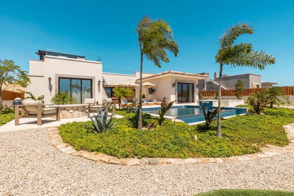 Cabo Luxury Las Tunas The Nacuii Residence is a refined luxury home crafted to exceed the expectations of even the most discerning buyer. Nestled on a generous and private 3,000 m² lot (0.73 acres), it's just a short, effortless stroll to the untouched, sandy shores of Las Tunas — perfect for enjoying the serene coastal landscape and dramatic sunsets. The home offers a thoughtful layout with 3 spacious bedrooms, a separate studio, a cozy TV lounge, and 6 full bathrooms, including two principal suites, a guest room, a detached studio, and a dedicated media or family room. Expansive sliding glass doors invite natural light throughout the interiors while showcasing tranquil garden for sale