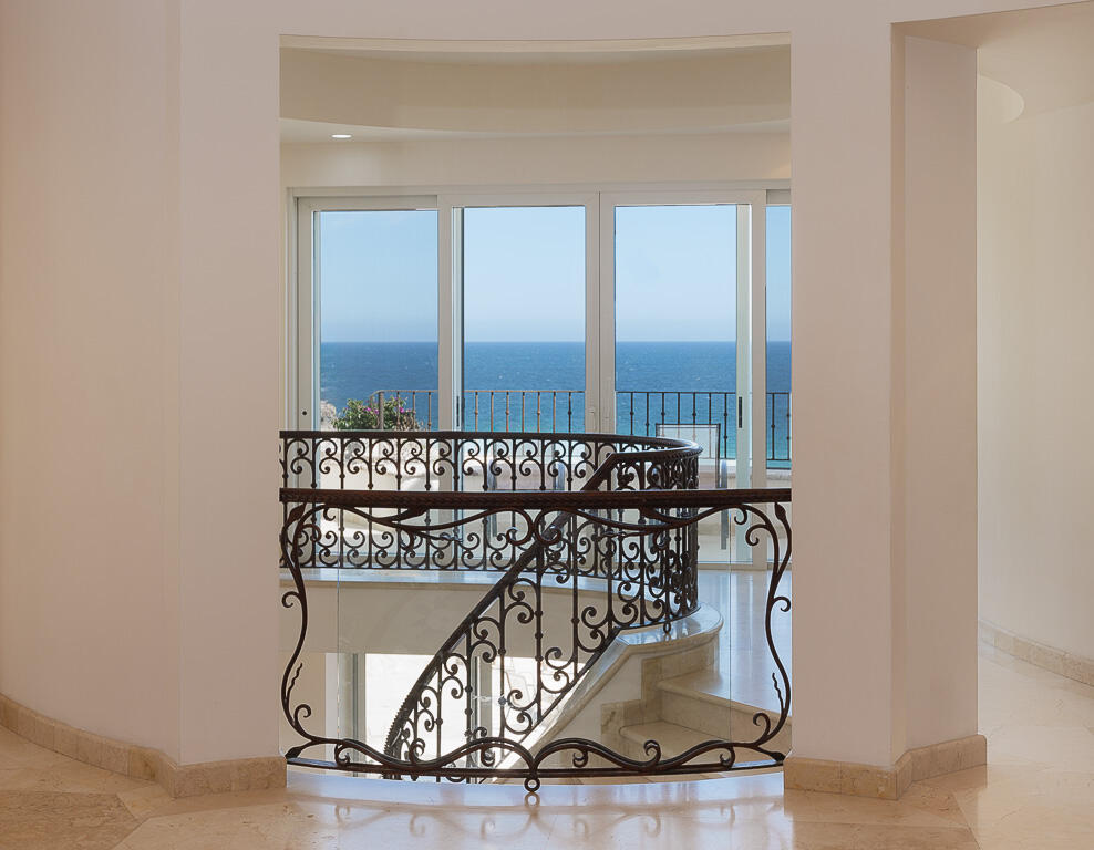 Cabo Luxury Pedregal Csl Villa Marcella sits on an exquisite piece of ocean front property in the exclusive community of Pedregal in Cabo San Lucas. This 6 bedroom 9 bathroom beach estate has a very private location with it's natural mountainside to it's left that make it perfect for entertaining large beach parties, family gatherings, it has even been known to host quite a few a weddings. The beach estate consists of outdoor fire pit, Olympic size swimming pool, jacuzzi, outdoor cooking area, indoor game and bar room accessible from the beach. Enjoy the long beach walks and beautiful Pacific sunrises and sunsets from this beach home. Excellent INVESTMENT property or private home on the beach. – Lote 15 Villa Marcella | Manzana 282, Cabo San Lucas, BS