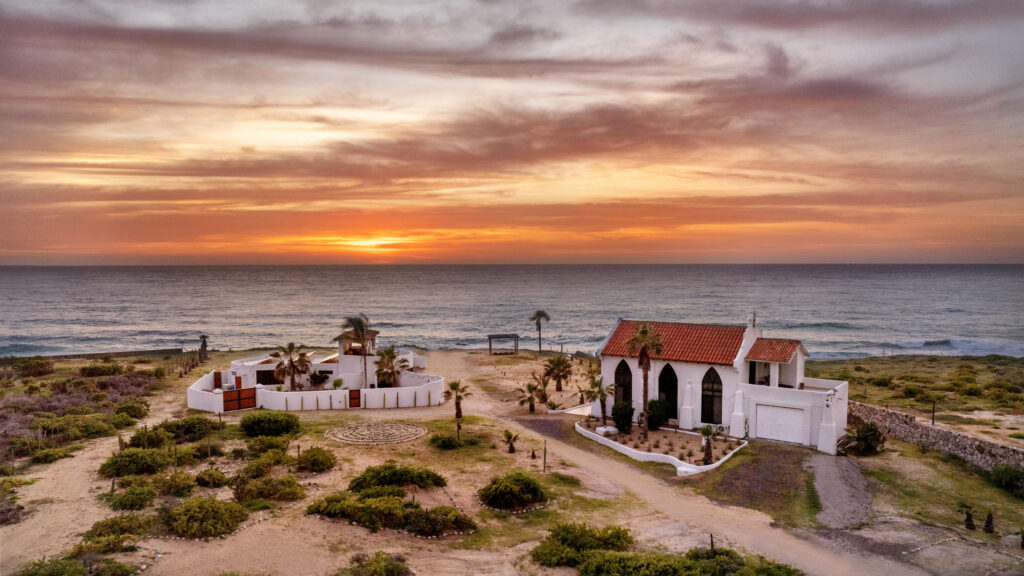 Cabo Luxury Elias Calles Welcome to Rancho 82 -- a rare 2.4-acre oceanfront property offering 190 feet of Pacific coastline, two charming Baja-style homes, and endless potential. With five titled lots, and easy access from Highway 19, this property could become a family compound, boutique retreat, or collection of oceanfront villas. The main home offers 3 bedrooms and 3 baths; the guest casita includes 3 bedrooms, 2 baths, and a rooftop terrace. Both feature authentic Mexican craftsmanship, handmade tiles, and sweeping ocean – Rancho 82, Pacific, BS